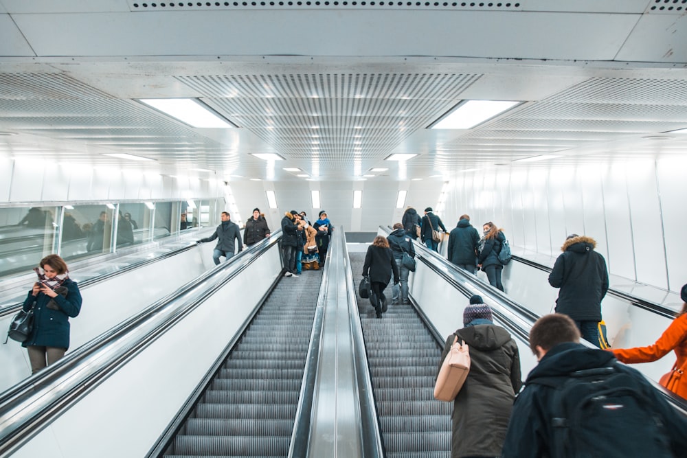 people standing on escalators\