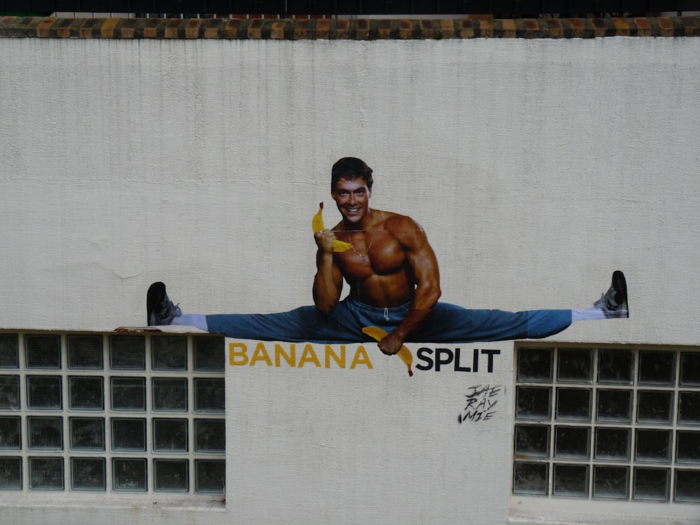 man holding banana while split wall painting