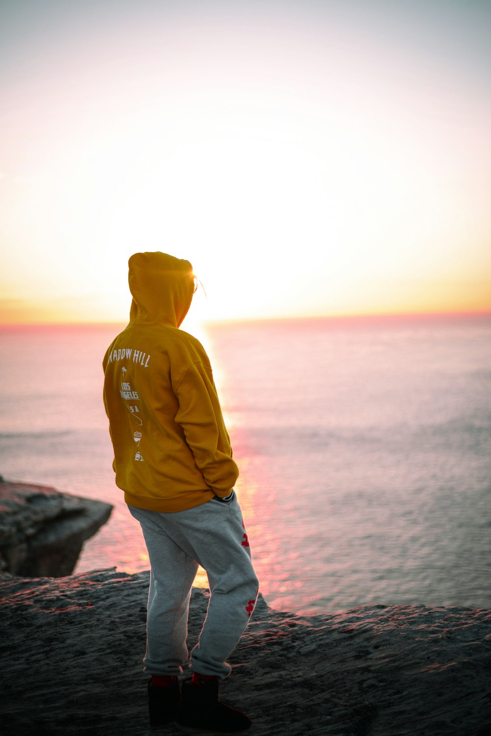 man wearing brown pullover hoodie