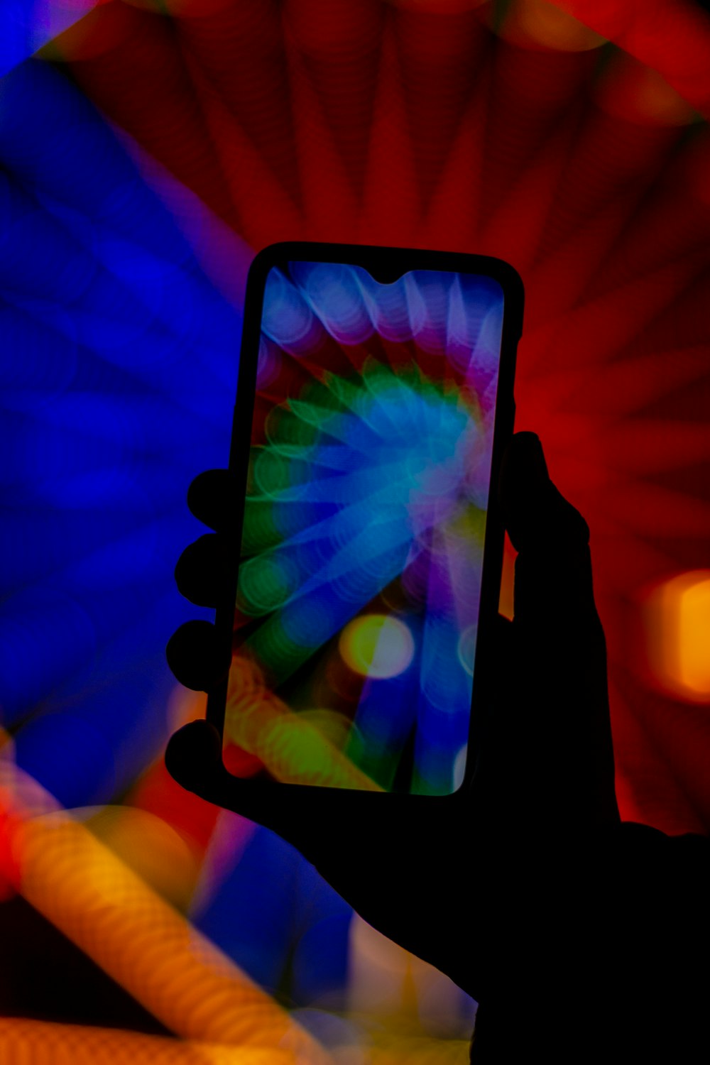 black smartphone displaying multicolored wallpaper