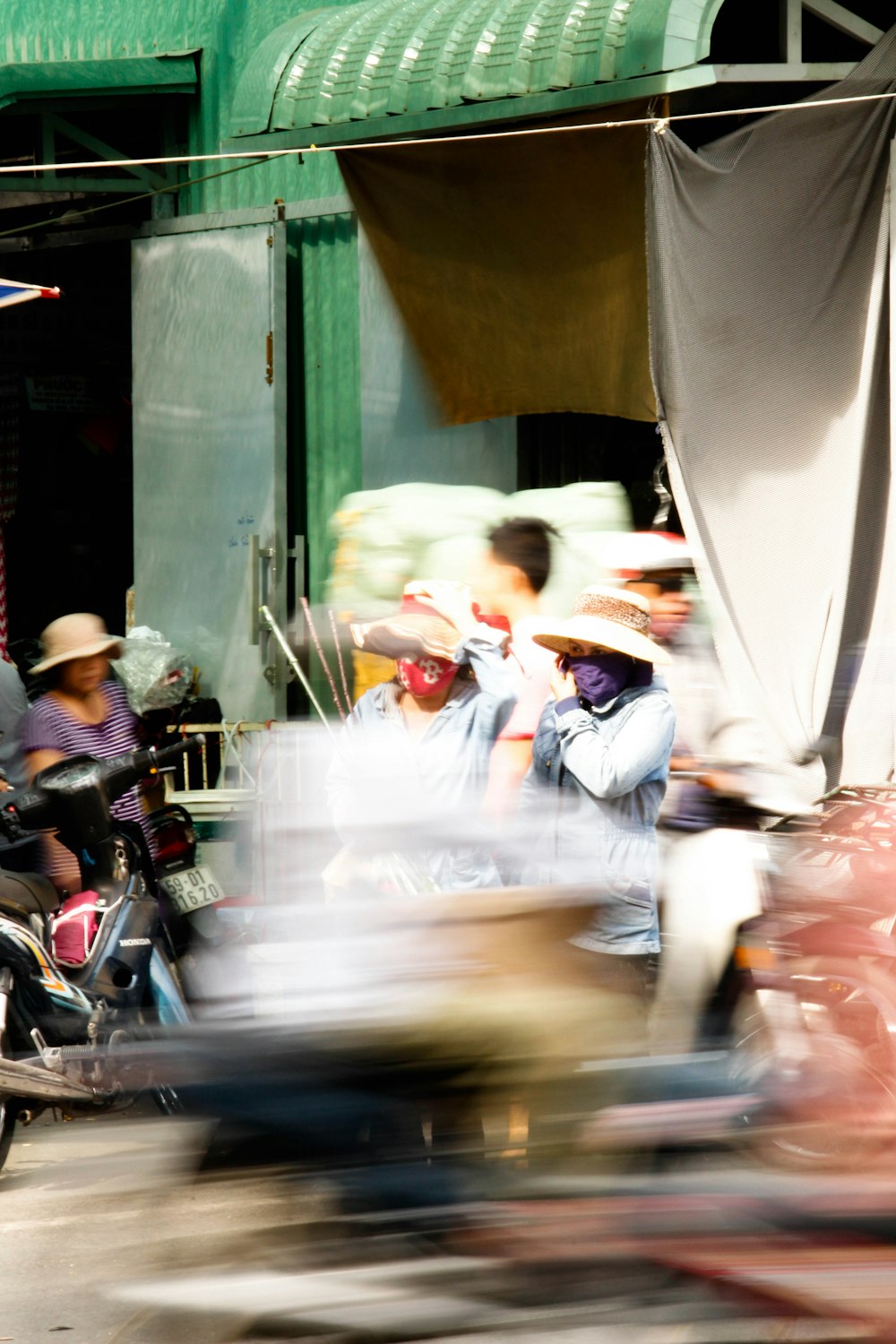 a blurry photo of people riding motorcycles down a street