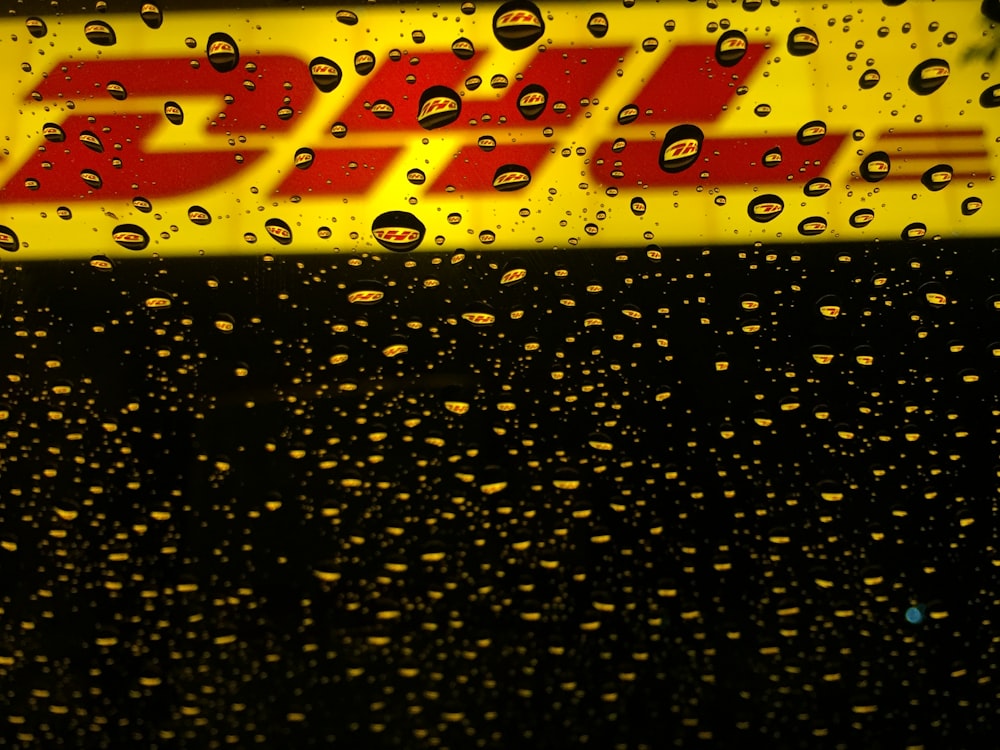 yellow and red DHL logo with waterdews