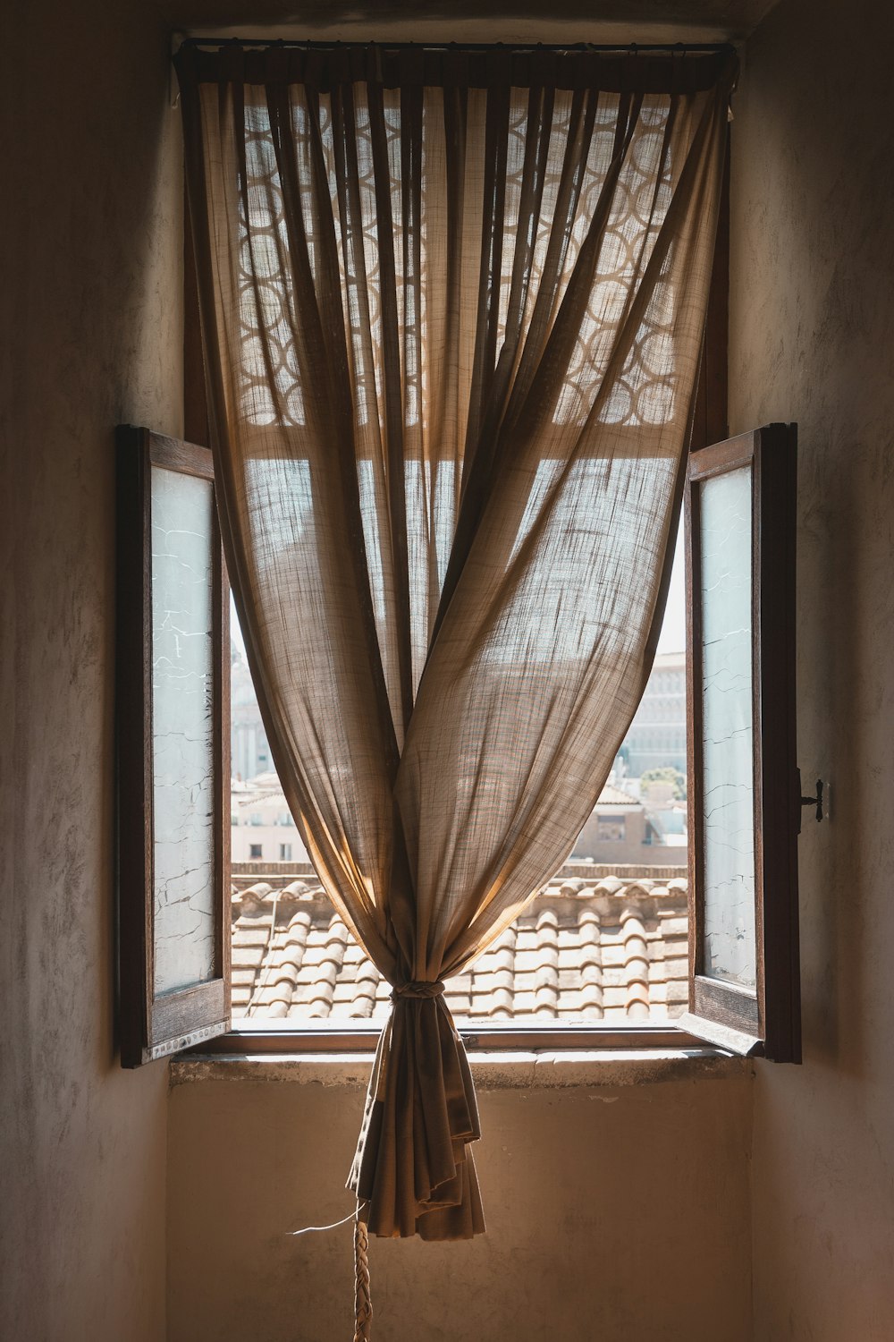 brown window curtain and opened window