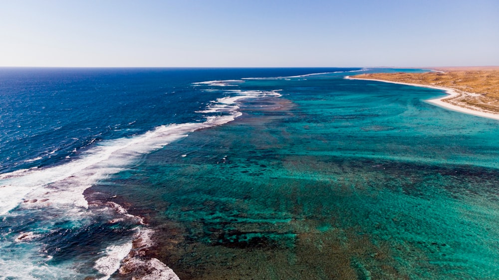 green and blue sea during daytime