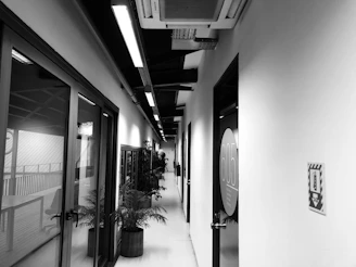 A row of smart doors with illuminated access panels in an office hallway