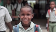 boy wearing blue backpack