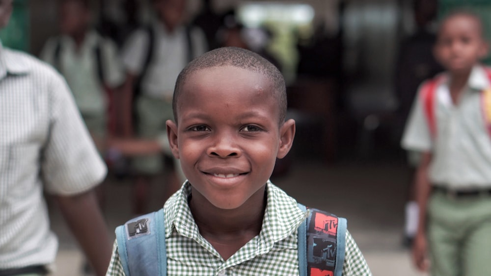 boy wearing blue backpack