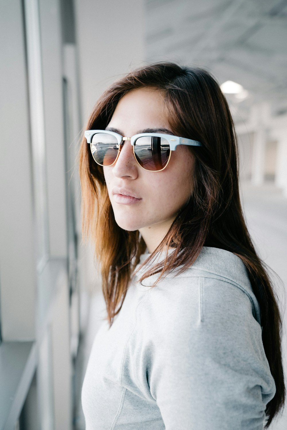 woman wearing white sunglasses standing