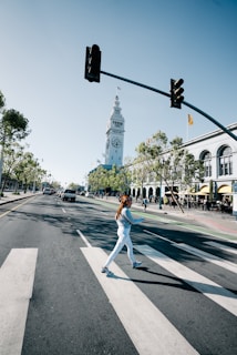 Model crossing a bustling crosswalk in Lumina Apparel’s latest athleisure line, embodying movement and energy.