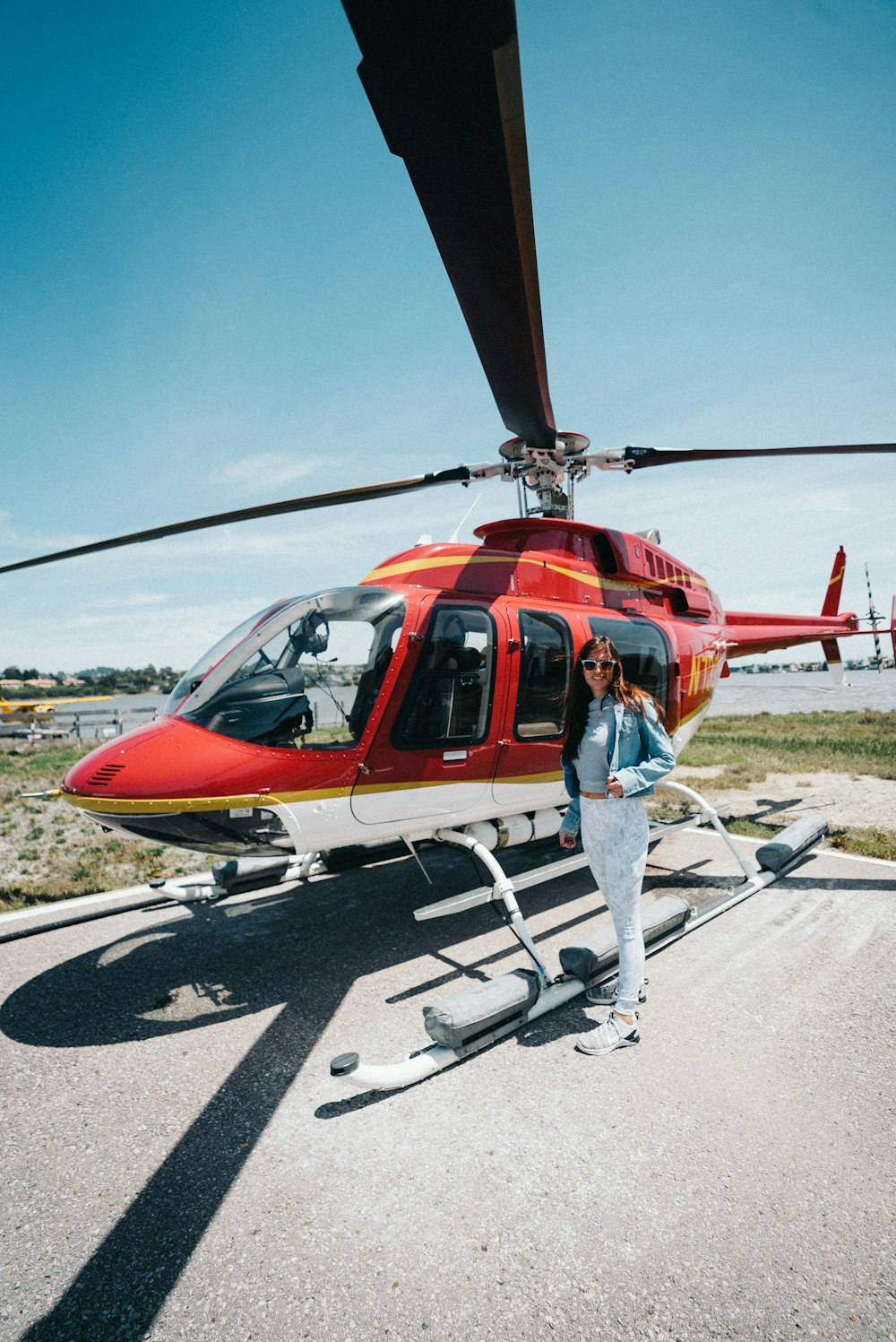 smiling woman standing near red helicopter