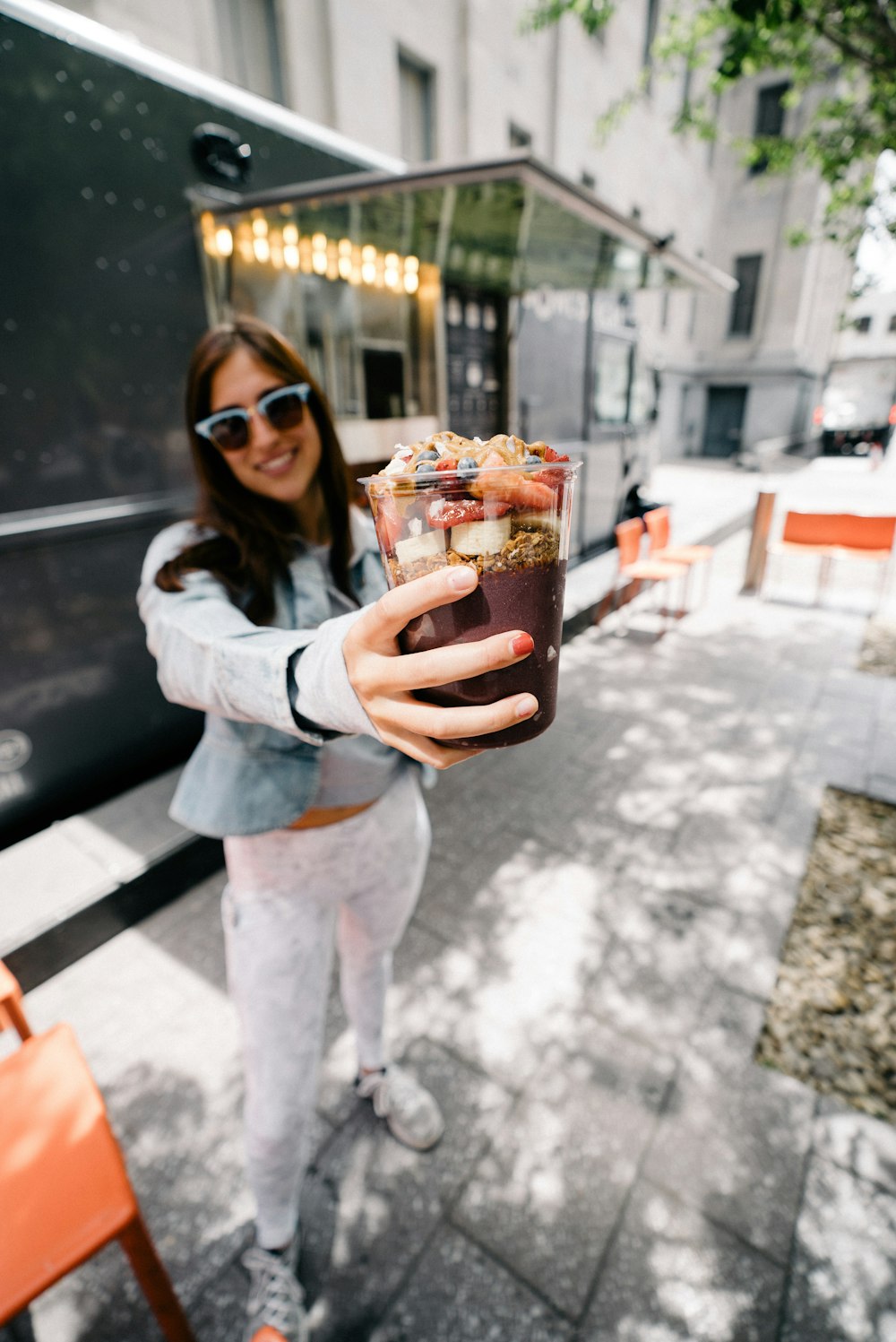 woman holding cup of chocolate shake