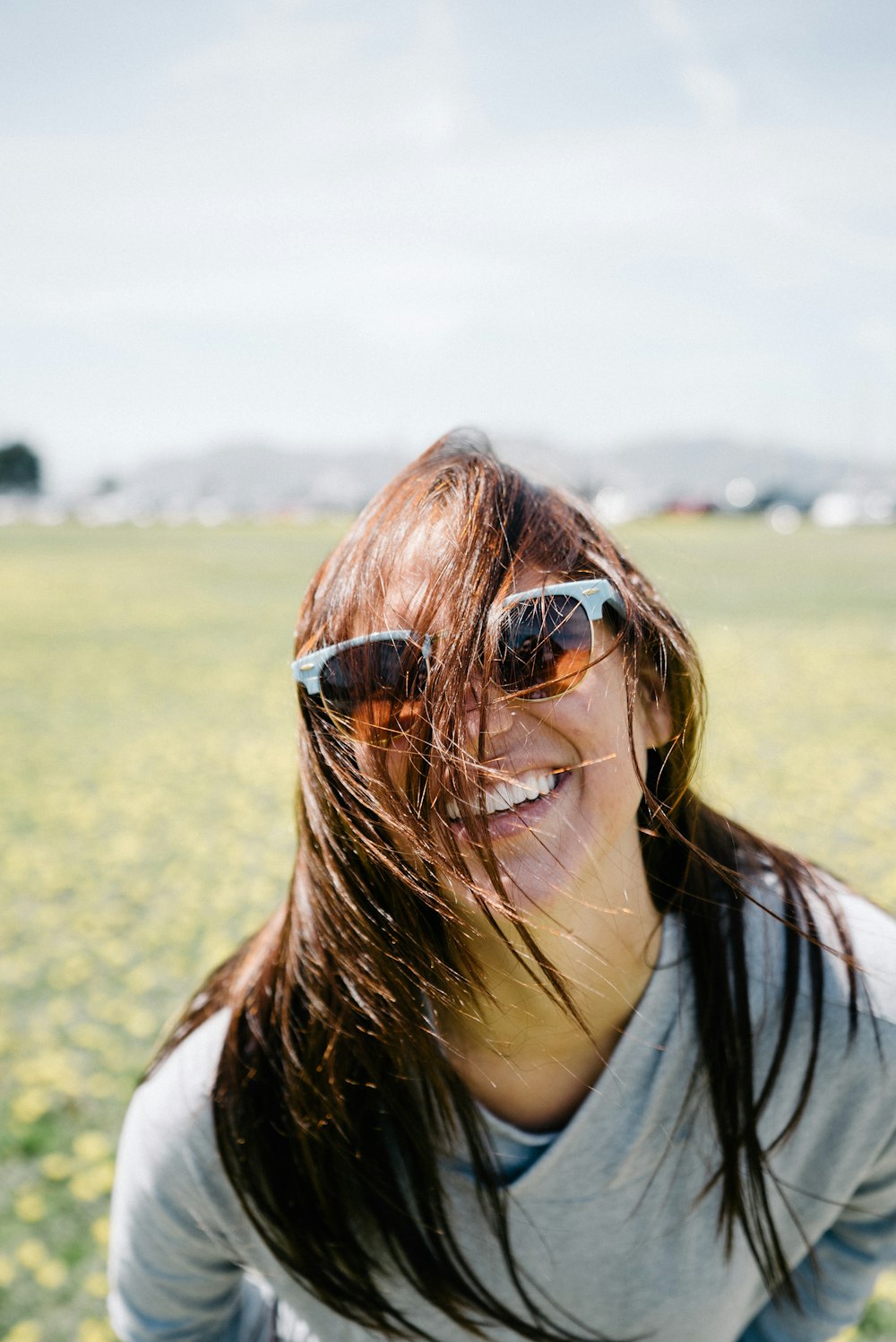 smiling woman in gray shirt