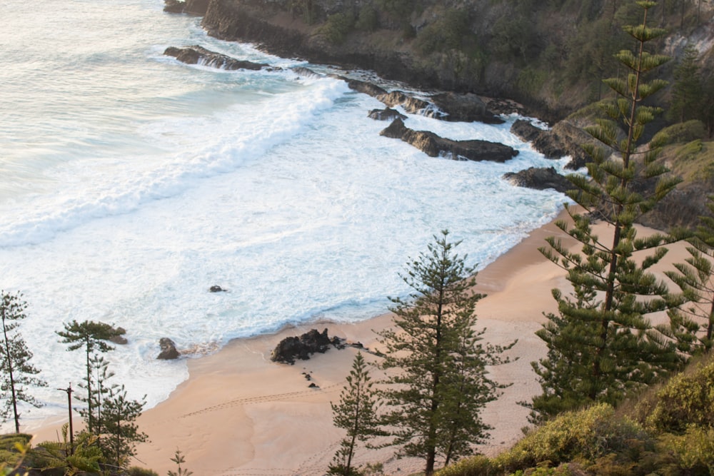 sea waves near the rock formation during daytime