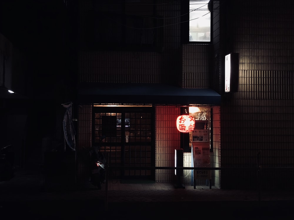 red and white pendant lamp on building