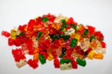 Close-up of colorful gummy bears spilling from a paper cone.