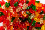 Colorful gummy bears stacked in creative packaging for a new candy line.