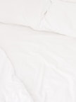 Comfortable bed with crisp white linens and soft pillows.