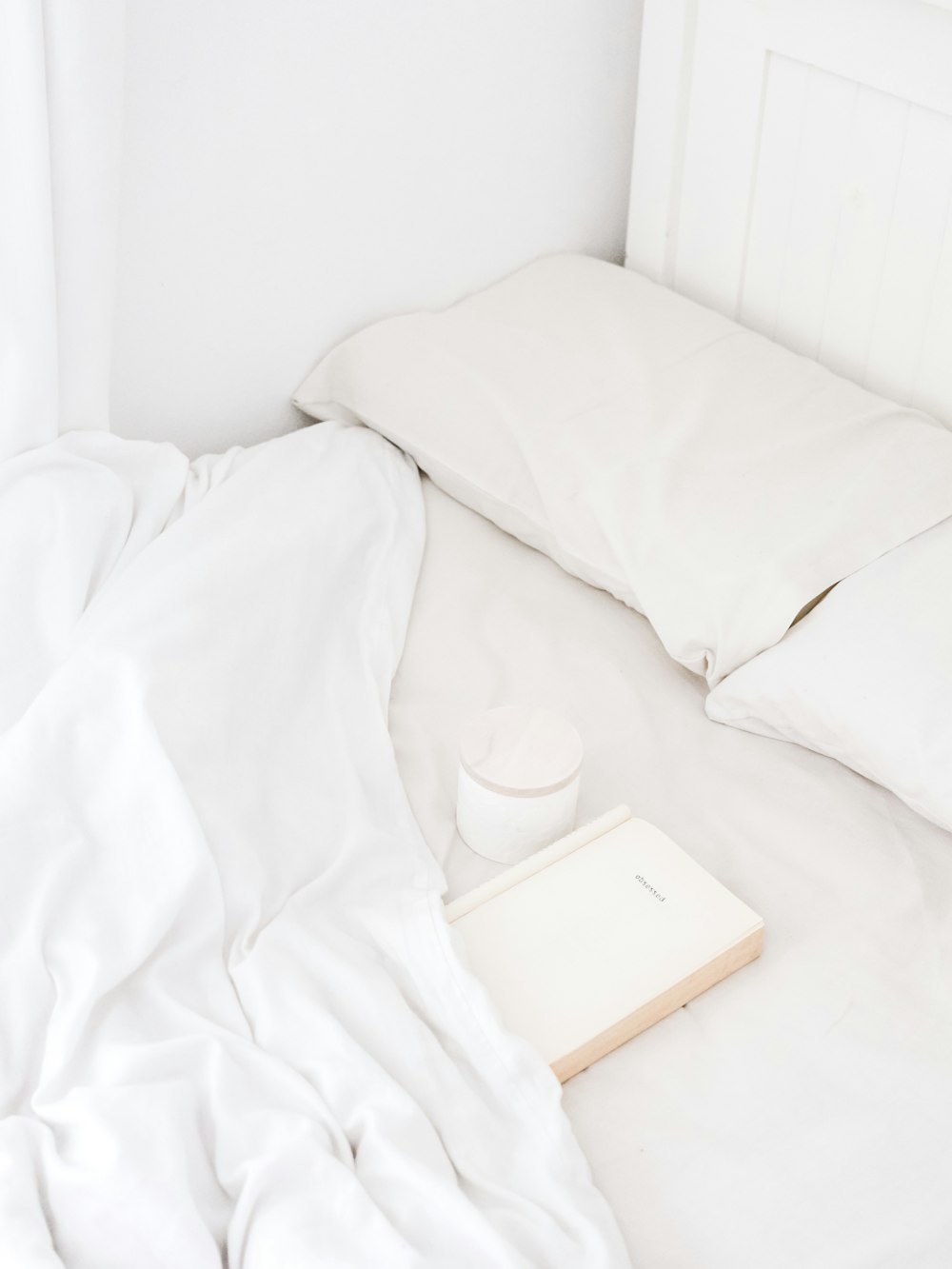 white portable speaker on bed