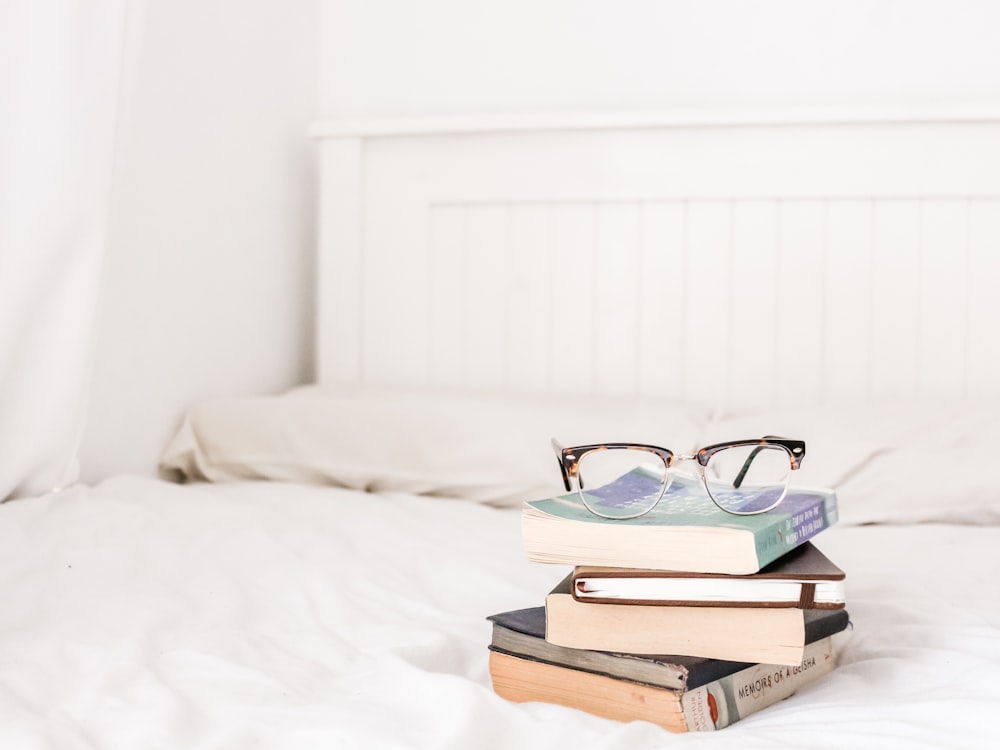 eyeglasses on pile of books