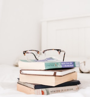 eyeglasses on top of filed books