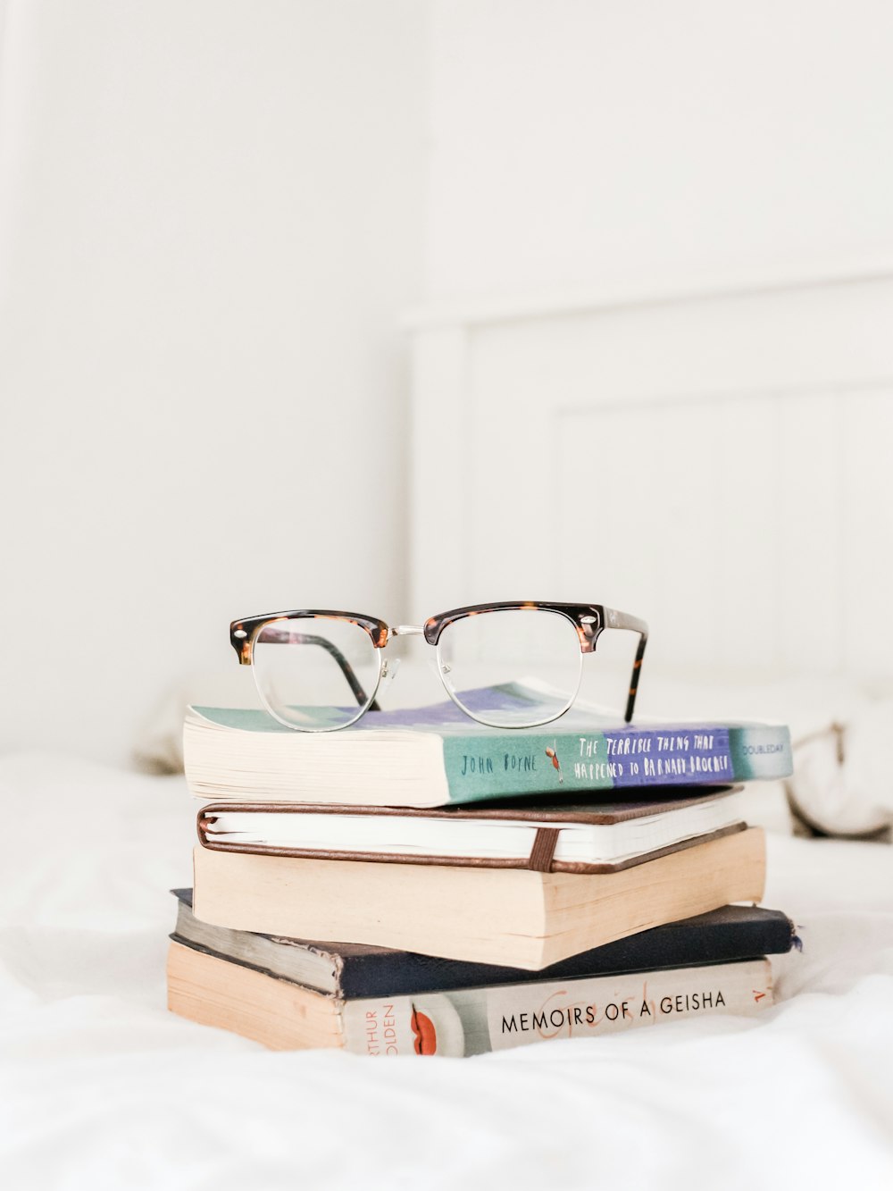 eyeglasses on top of filed books