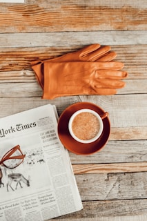 brown leather gloves near mug