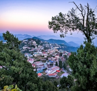 aerial photography of city surrounded by mountains during daytime