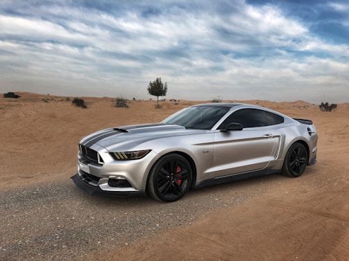 A sleek sports car on a desert road showcasing its design.