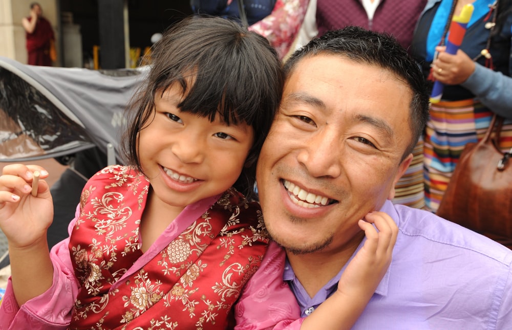 smiling man beside girl