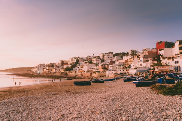 Colorful fishing boats resting by the pier in a lively coastal village