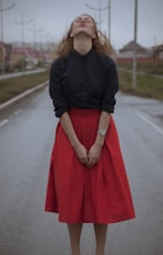 woman wearing black dress shirt and red long skirt