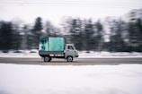 time lapse photography of white cab forward truck surrounded by snow