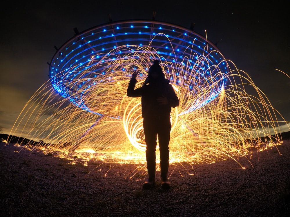 silhouette of person with fireworks backbround