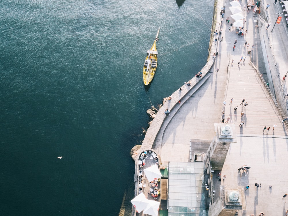 aerial photography of white ship beside yellow boat during daytime