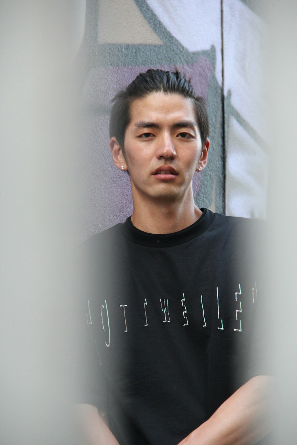 man wearing black and white printed crew-neck t-shirt standing