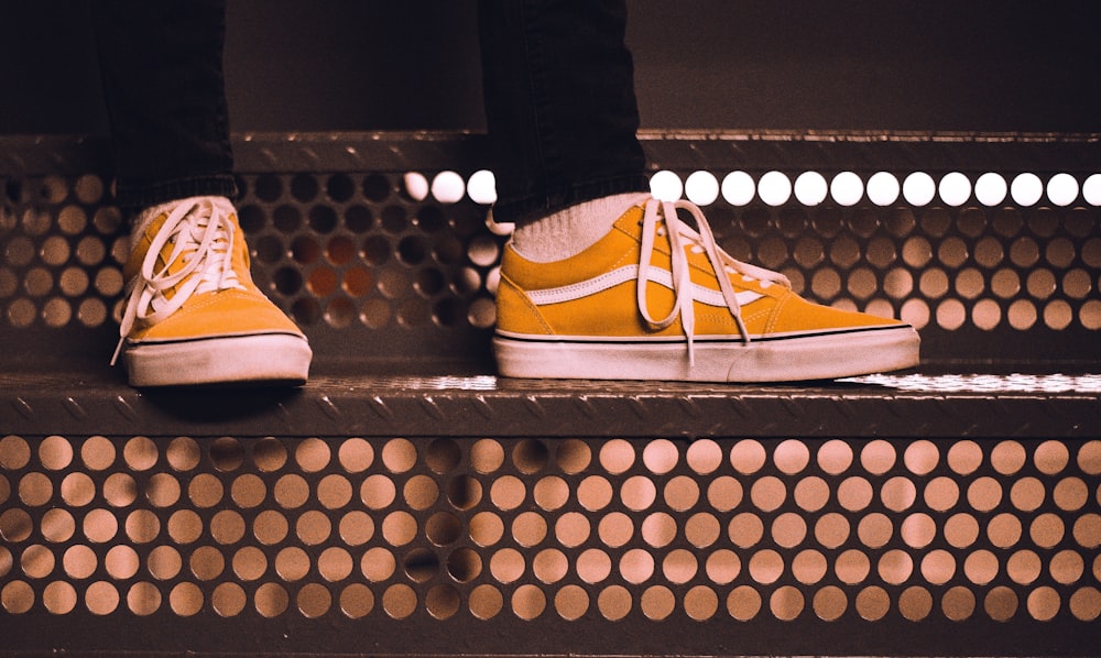 person with yellow Vans sneakers