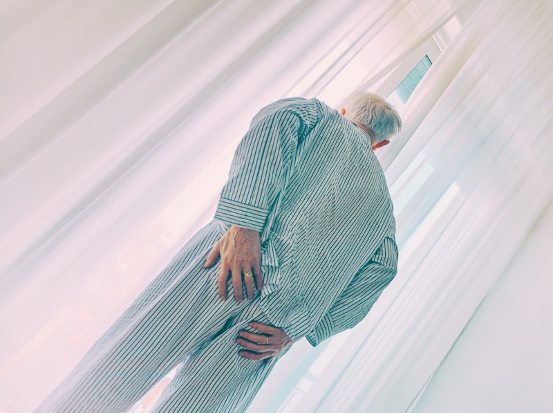 Senior doing gentle stretching exercises on a mat for sciatica relief