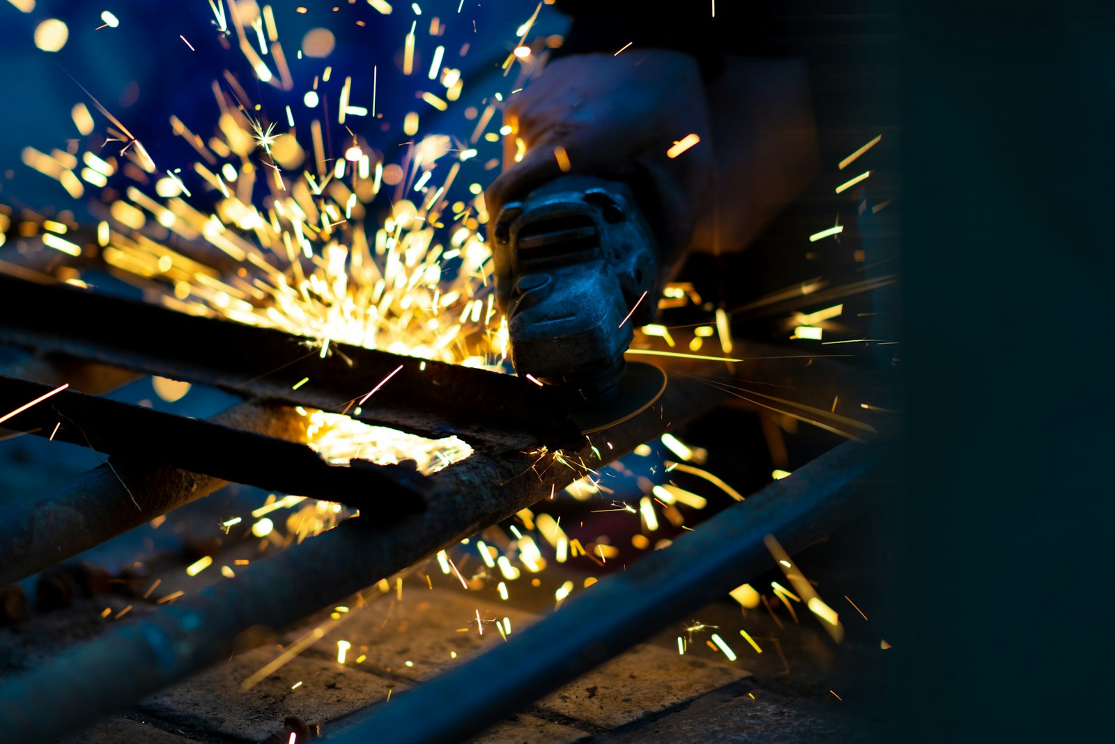 Sony a99 II + Sony Sonnar T* 135mm F1.8 ZA sample photo. Person using angle grinder photography