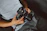 A happy customer holding a new camera with a bright smile in a cozy home setting.