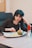 woman sitting in front of tray of food