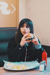woman holding burger