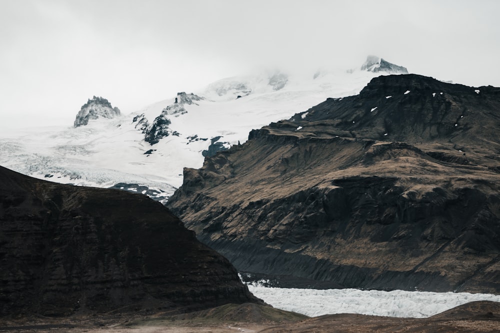 snow capped mountains under white sky