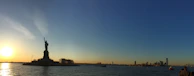 A panoramic view of the Hussain Sagar lake with the Buddha statue at sunset.