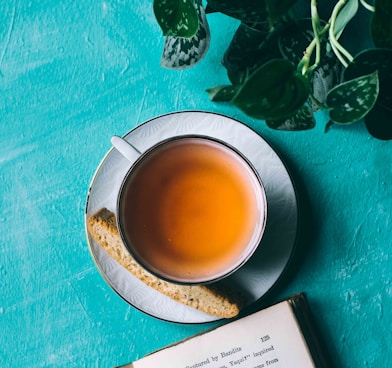 yellow liquid in white ceramic teacup