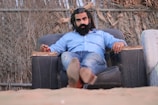 man sitting on sofa