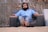 man sitting on sofa