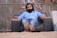 man sitting on sofa