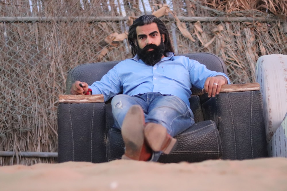 man sitting on sofa