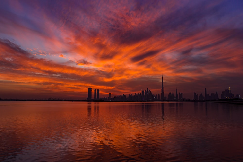 view of body of water near city during sunset