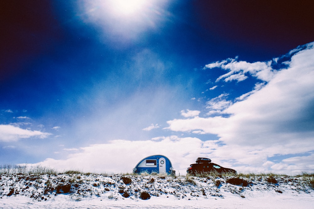 white and blue trailer under blue calm sky